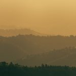 Hazy orange landscape with hills rolling in the distance