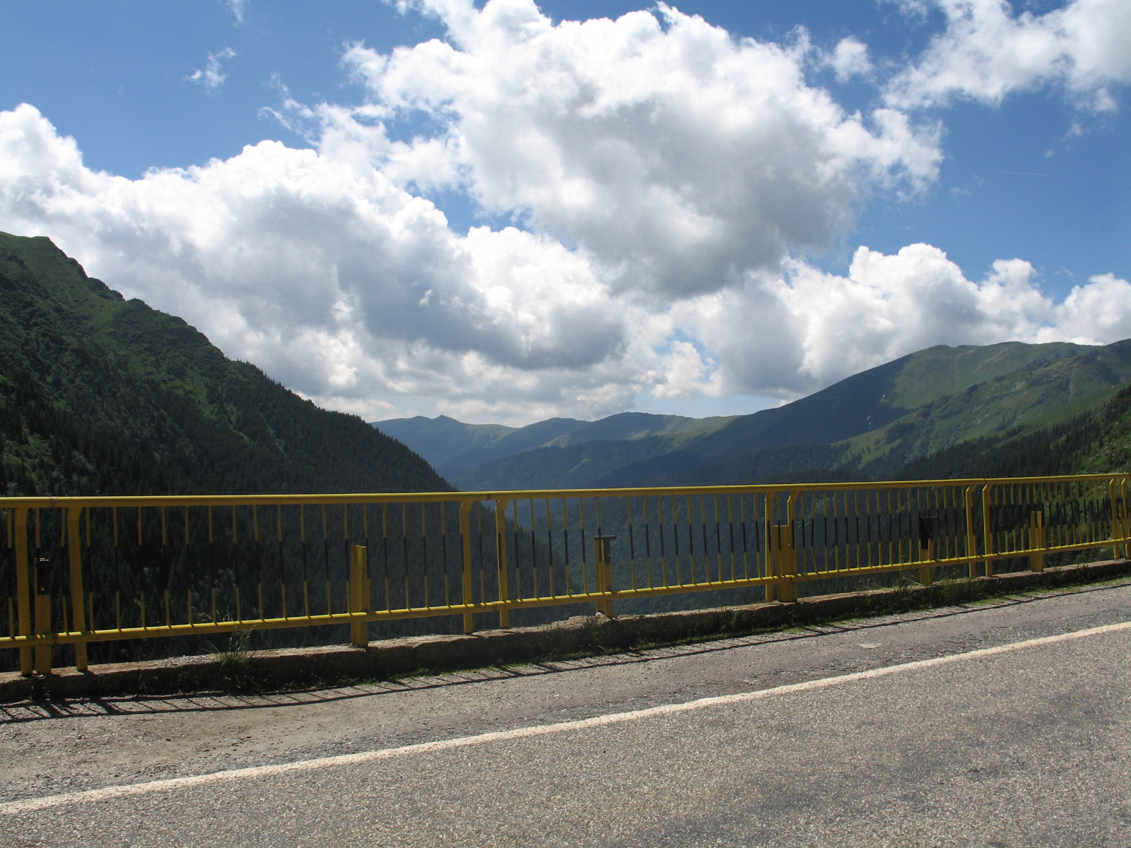 Landscape from a road with a yellow railing
