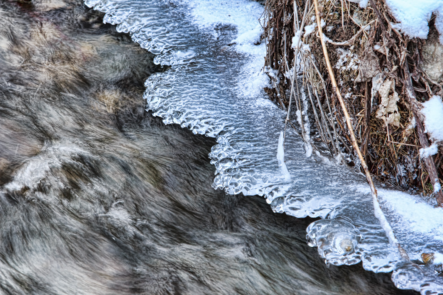 Ice on the edge of a stream in winter