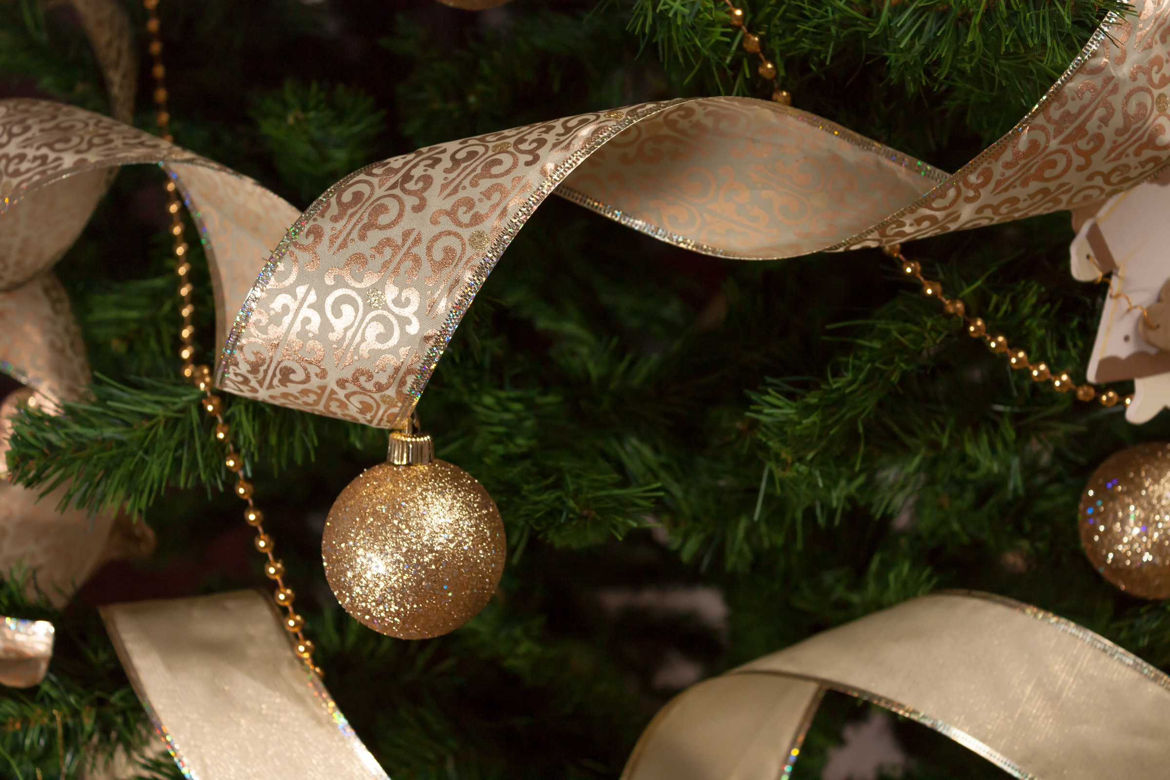 Christmas tree decorations with golden ribbon and beads