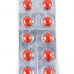 Red tablets in blister packs