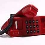 Red telephone on white background