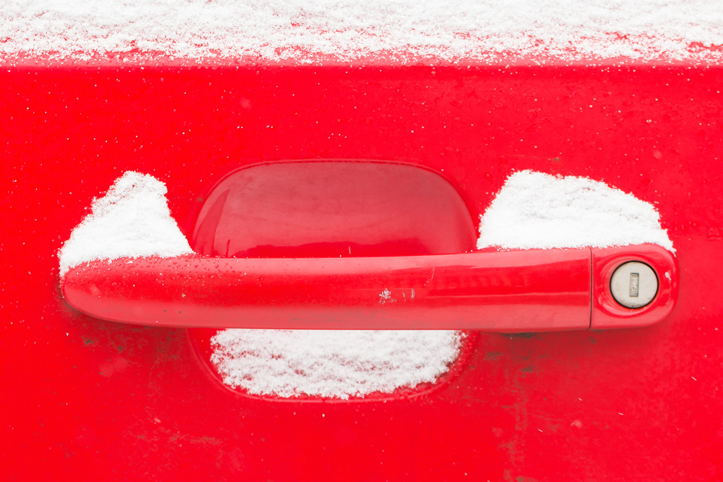 Red door handle in winter