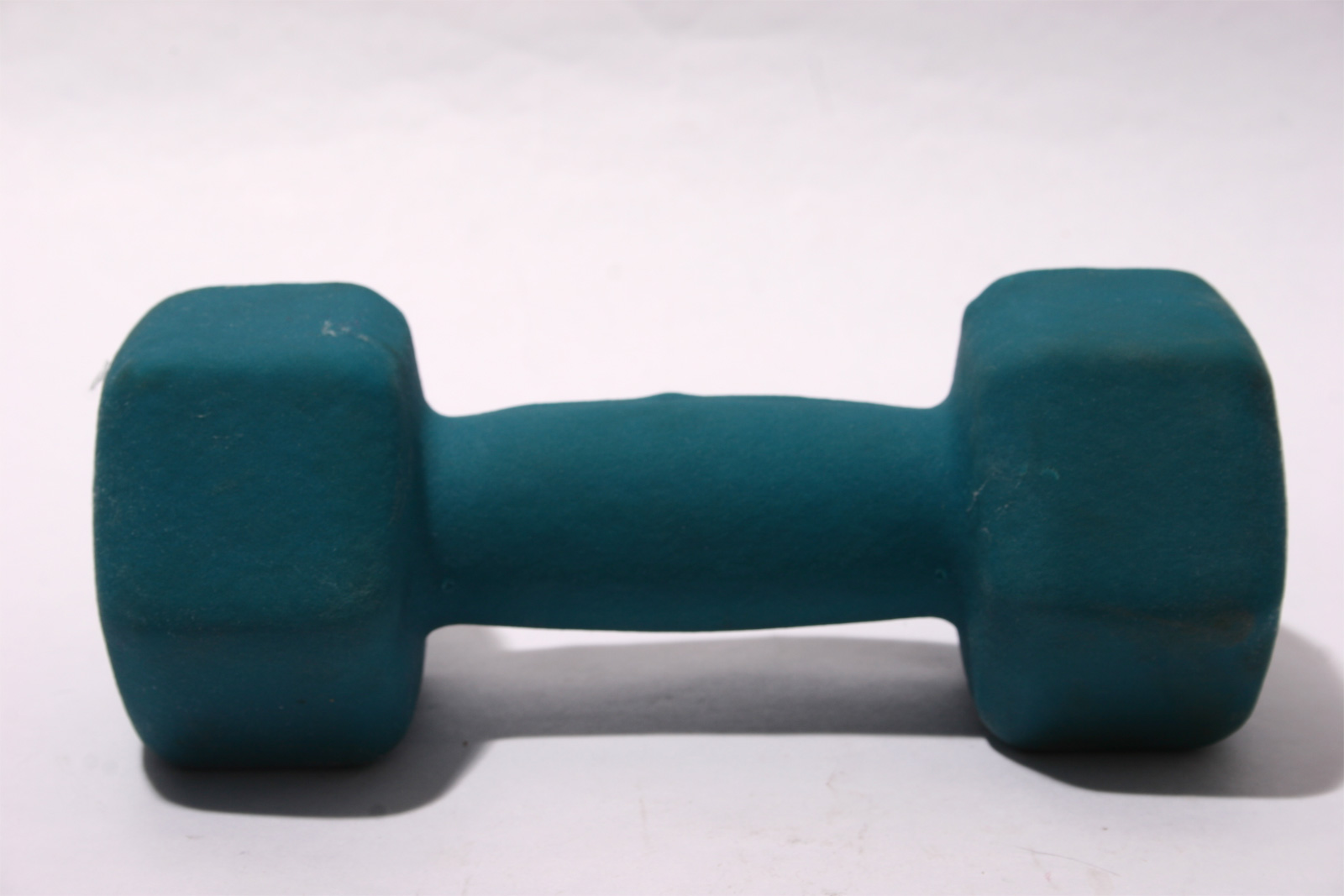 Green dumbbell weight on white background