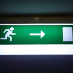 Dark exit sign with vibrant light