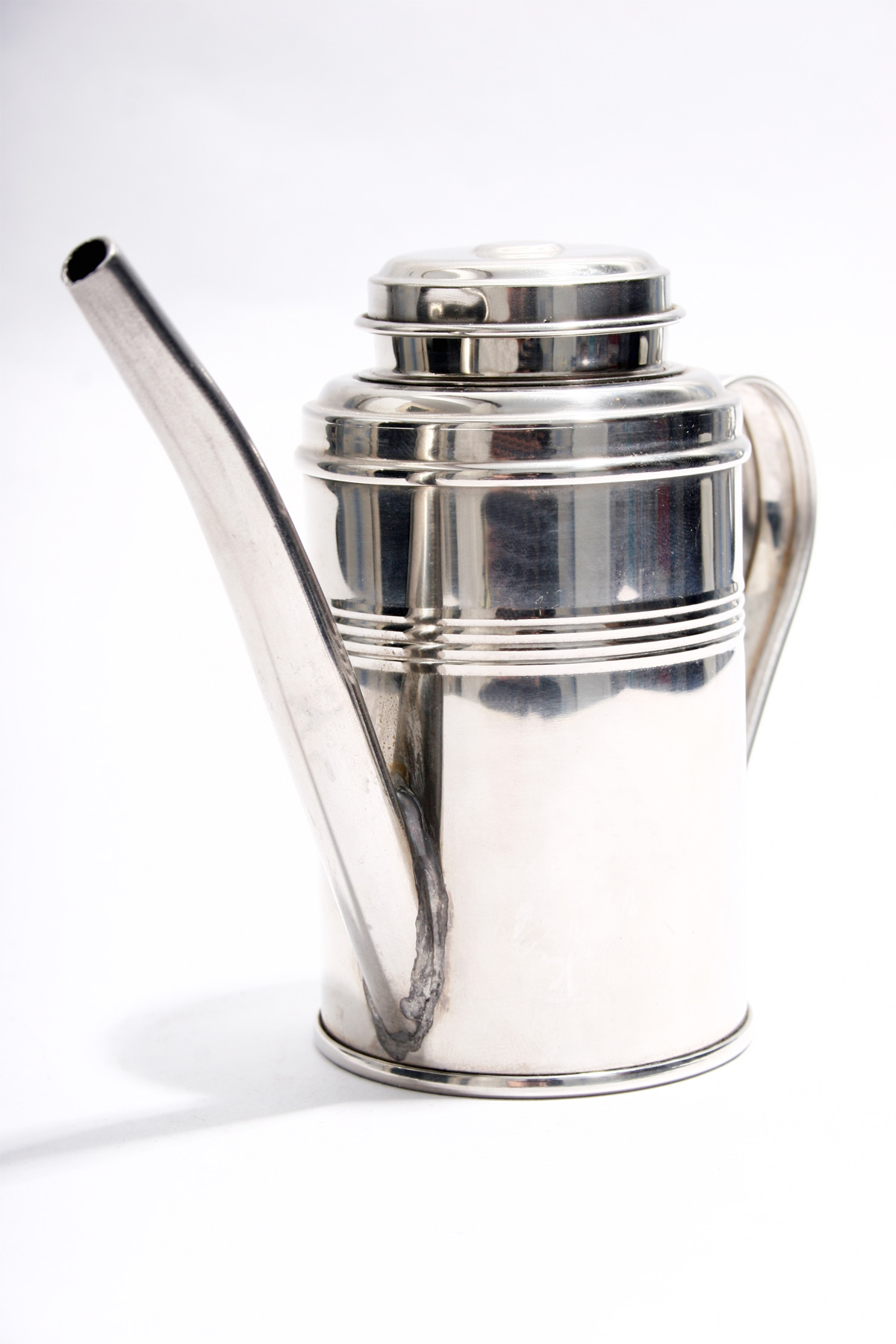 Stainless steel teapot on white background