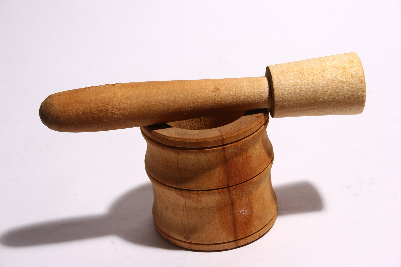 Wooden mortar and pestle on white