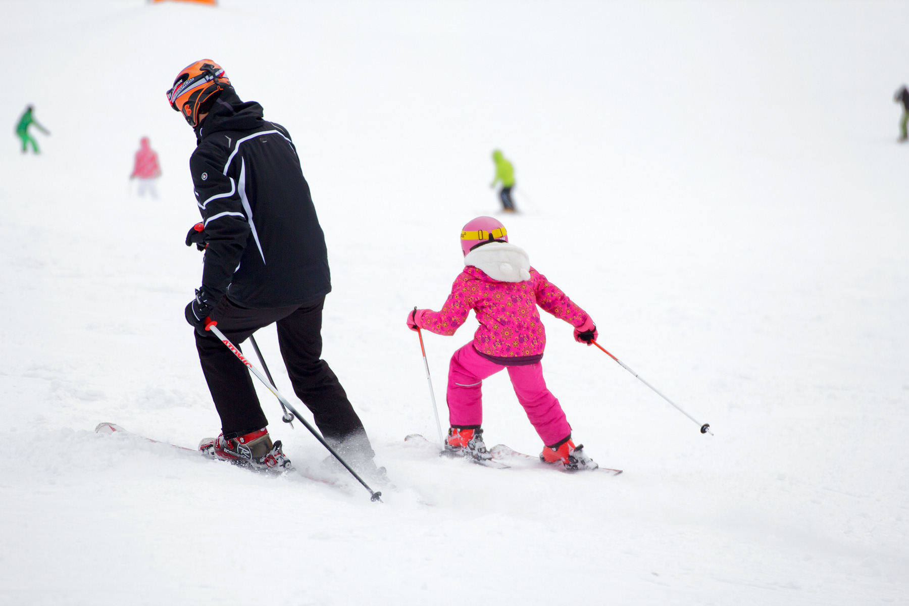 Father and daughter skiing