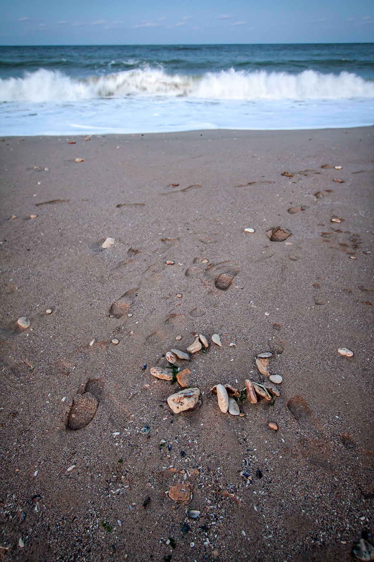 Footprints on a deserted beach in early autumn
